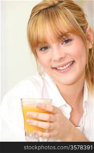 Blond woman drinking orange juice
