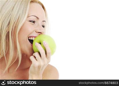 blond woman eat green apple on white. woman eat green apple