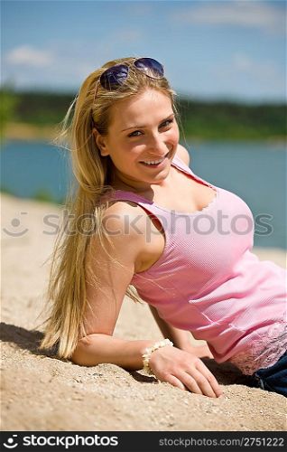 Blond woman enjoy summer sun lying on beach