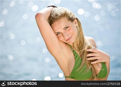 Blond woman enjoy summer sun wearing bikini at sea