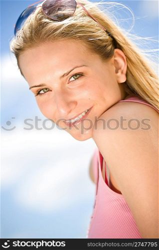 Blond woman enjoy summer sun with sunglasses at sea