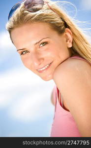 Blond woman enjoy summer sun with sunglasses at sea