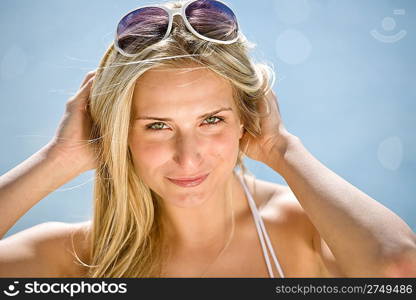 Blond woman enjoy summer sun with sunglasses at seashore