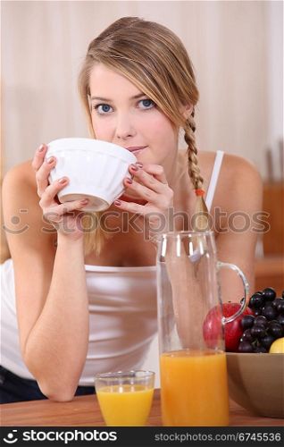 Blond woman having breakfast