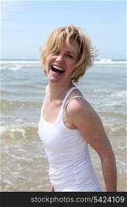 Blond woman having fun at the beach