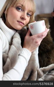 Blond woman holding a mug of coffee