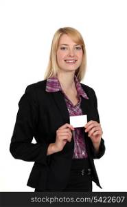 Blond woman holding business card