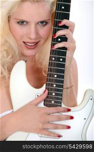 Blond woman holding electric guitar