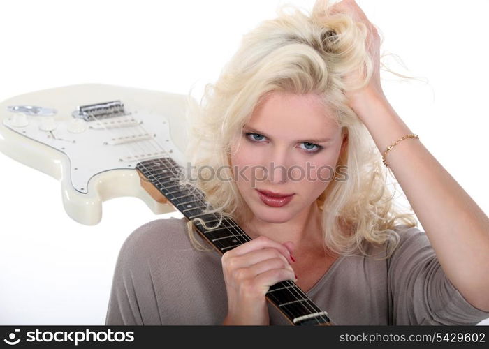 Blond woman holding electric guitar