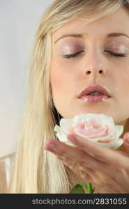 Blond woman holding flower