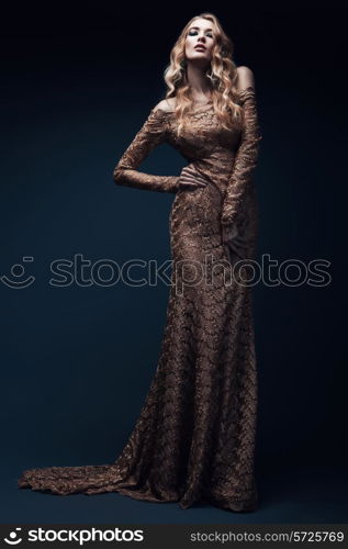 blond woman in long gold dress