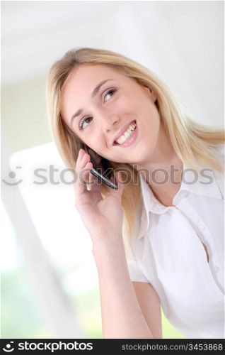 Blond woman in office talking on the phone