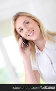 Blond woman in office talking on the phone