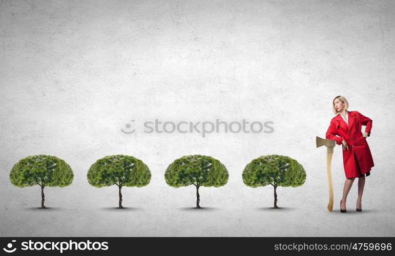 Blond woman in red coat with axe and green tree. Protect forests