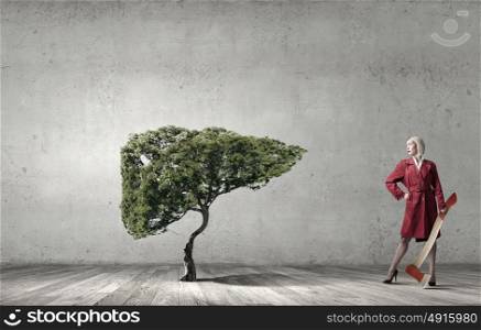 Blond woman in red coat with axe and green tree. Protect forests