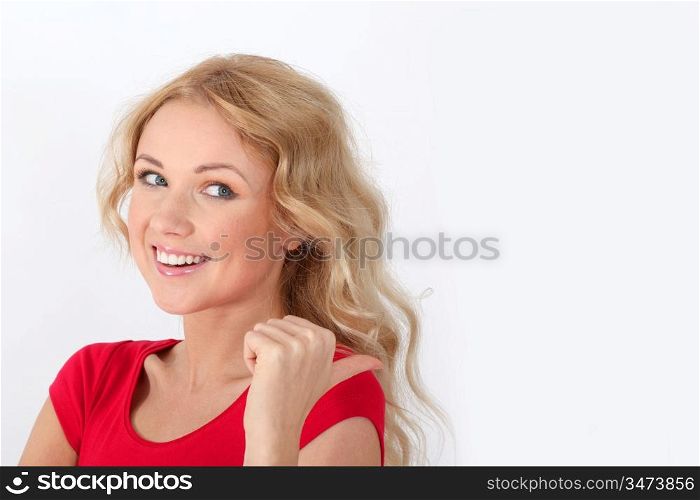 Blond woman in red shirt designating something with thumb up