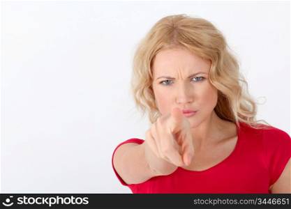 Blond woman in red shirt pointing at camera