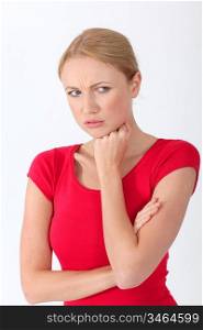 Blond woman in red shirt with upset look on her face