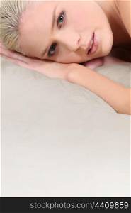 Blond woman laid on mattress