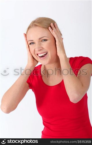 Blond woman laughing with hands on ears