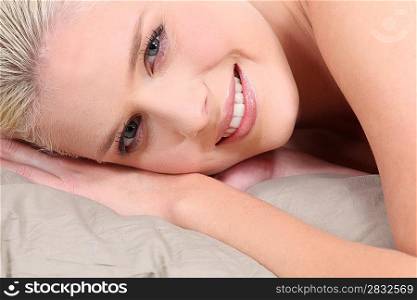 Blond woman laying in bed