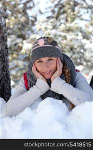Blond woman laying in the snow