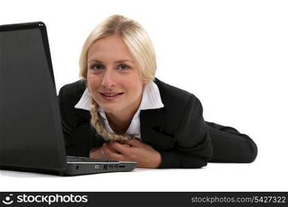 Blond woman laying with laptop