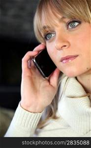 Blond woman making telephone call