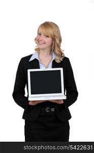 Blond woman presenting laptop
