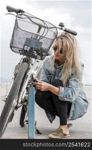 blond woman putting bike lock
