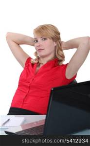 Blond woman relaxing at desk