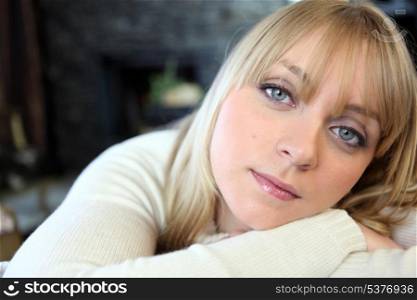 Blond woman relaxing at home on sofa