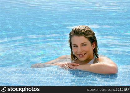 Blond woman relaxing in pool