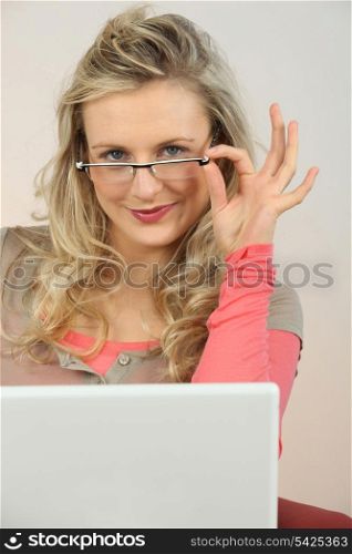 Blond woman sitting by her laptop