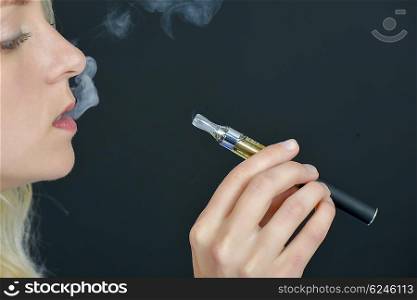 Blond woman smoking an electronic cigarette