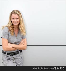Blond woman standing on grey background