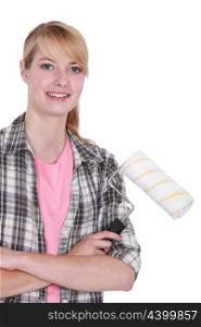Blond woman stood with paint roller