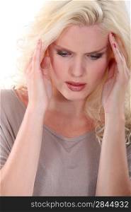 Blond woman suffering from head ache