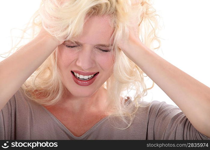 Blond woman suffering from headache