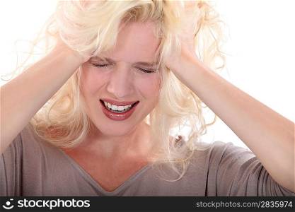 Blond woman suffering from headache