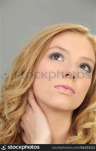 Blond woman suffering from sore neck