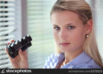 Blond woman using binoculars