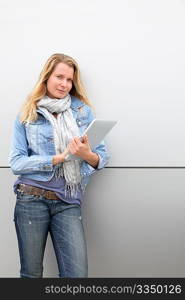 Blond woman using electronic tablet