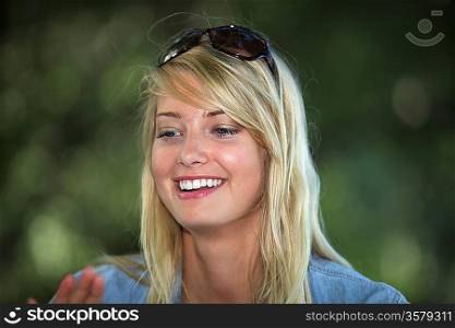 Blond woman wearing sunglasses on the top of her head