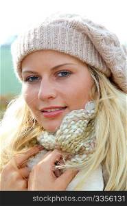 Blond woman wearing wool cap in autumn