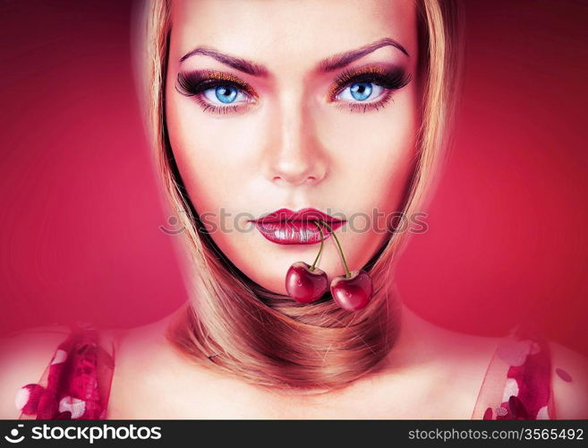 blond woman with blue eyes and cherry in mouth