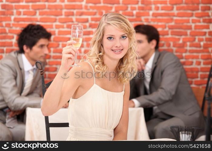 Blond woman with champagne in restaurant