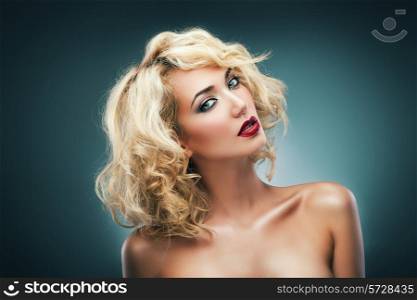 blond woman with curly hair and red lips