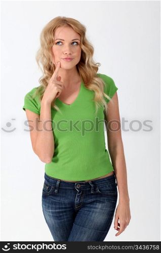 Blond woman with green shirt having thoughtful look