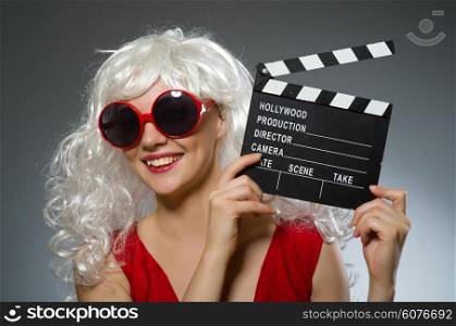 Blond woman with movie board